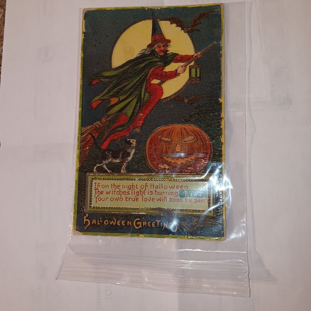 1910 antique Halloween postcard featuring a scene of a flying witch, bats